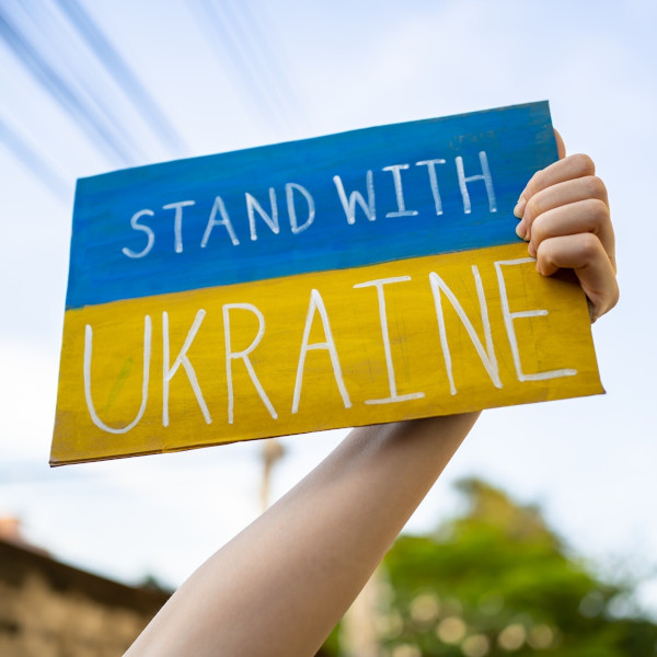 person holding stand with ukrain sign